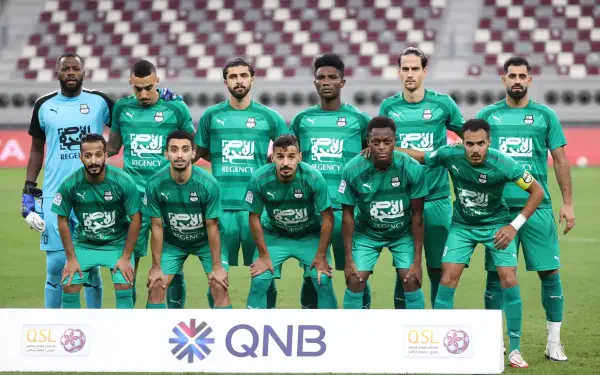 HD desktop wallpaper: Al-Ahli Saudi FC squad lined up on the pitch before a Saudi Pro League soccer match.