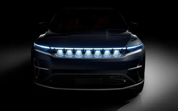 Front view of a Jeep Wagoneer S electric 4x4 with glowing LED grille and headlights, presented as an 8K Ultra HD PC desktop wallpaper/background.
