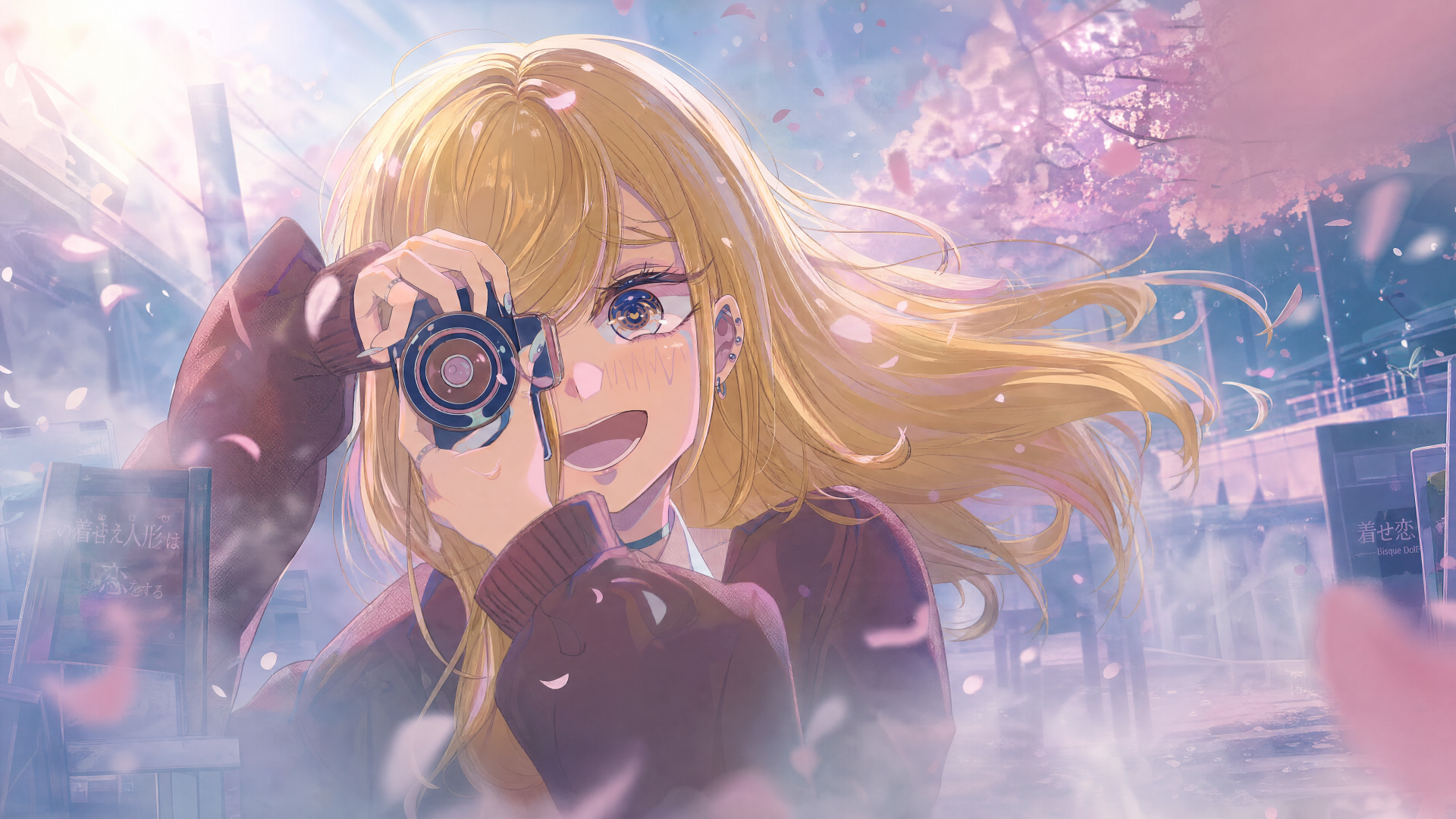 My Dress-Up Darling 4K Ultra HD PC desktop wallpaper/background: cheerful blonde girl holding a camera beneath falling cherry blossoms, wind-tossed hair and glowing pastel light.