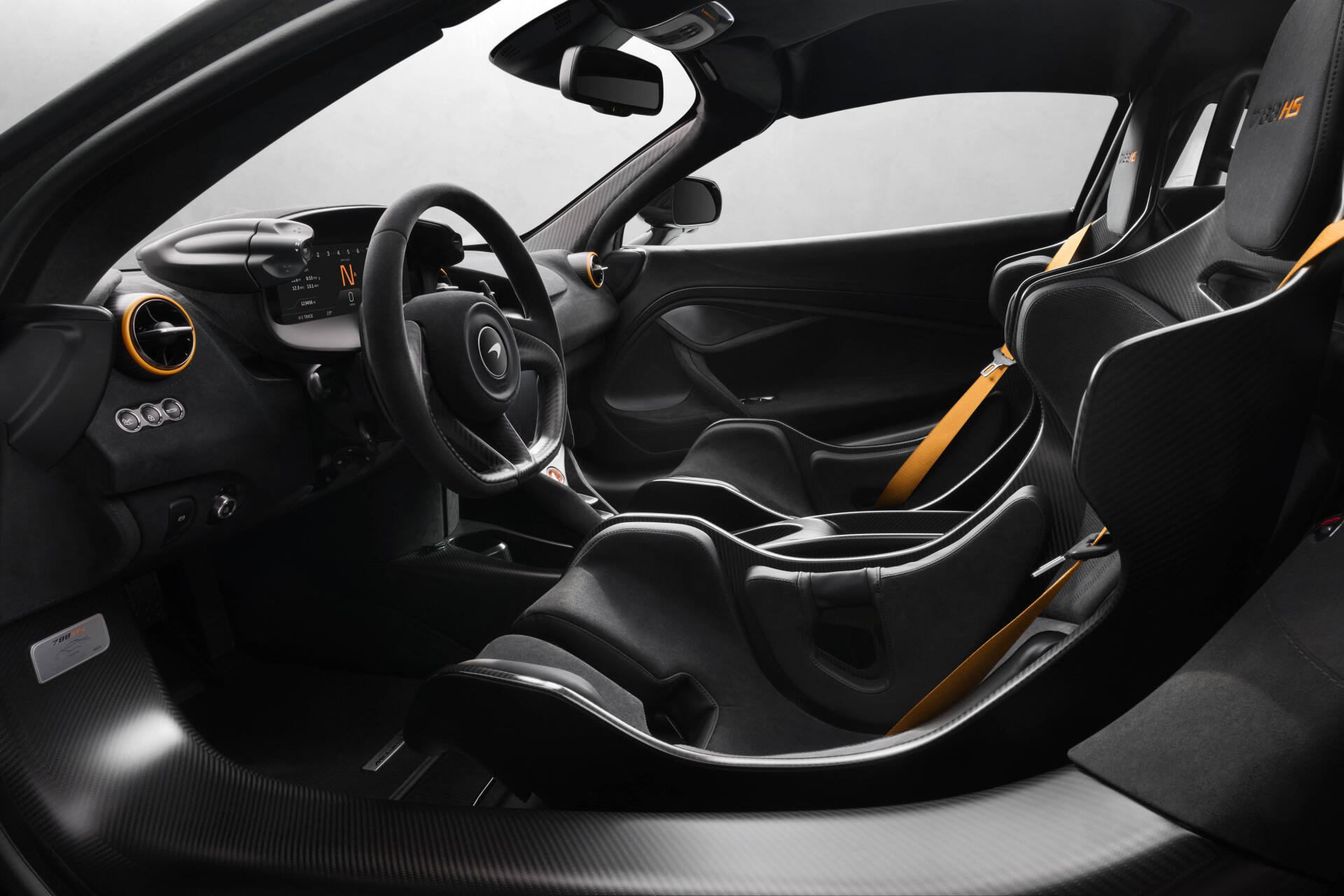 Interior view of a McLaren 788HS sports car with carbon-fiber racing seats, yellow harness accents and a minimalist cockpit — 8K Ultra HD PC desktop wallpaper.