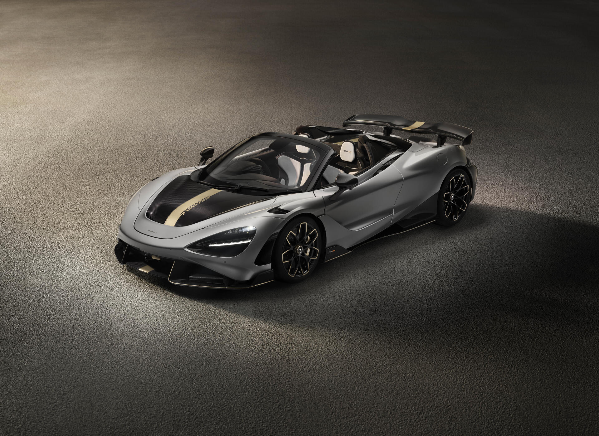 Silver McLaren 788HS convertible roadster on textured asphalt, presented as an 8K Ultra HD PC desktop wallpaper and background.