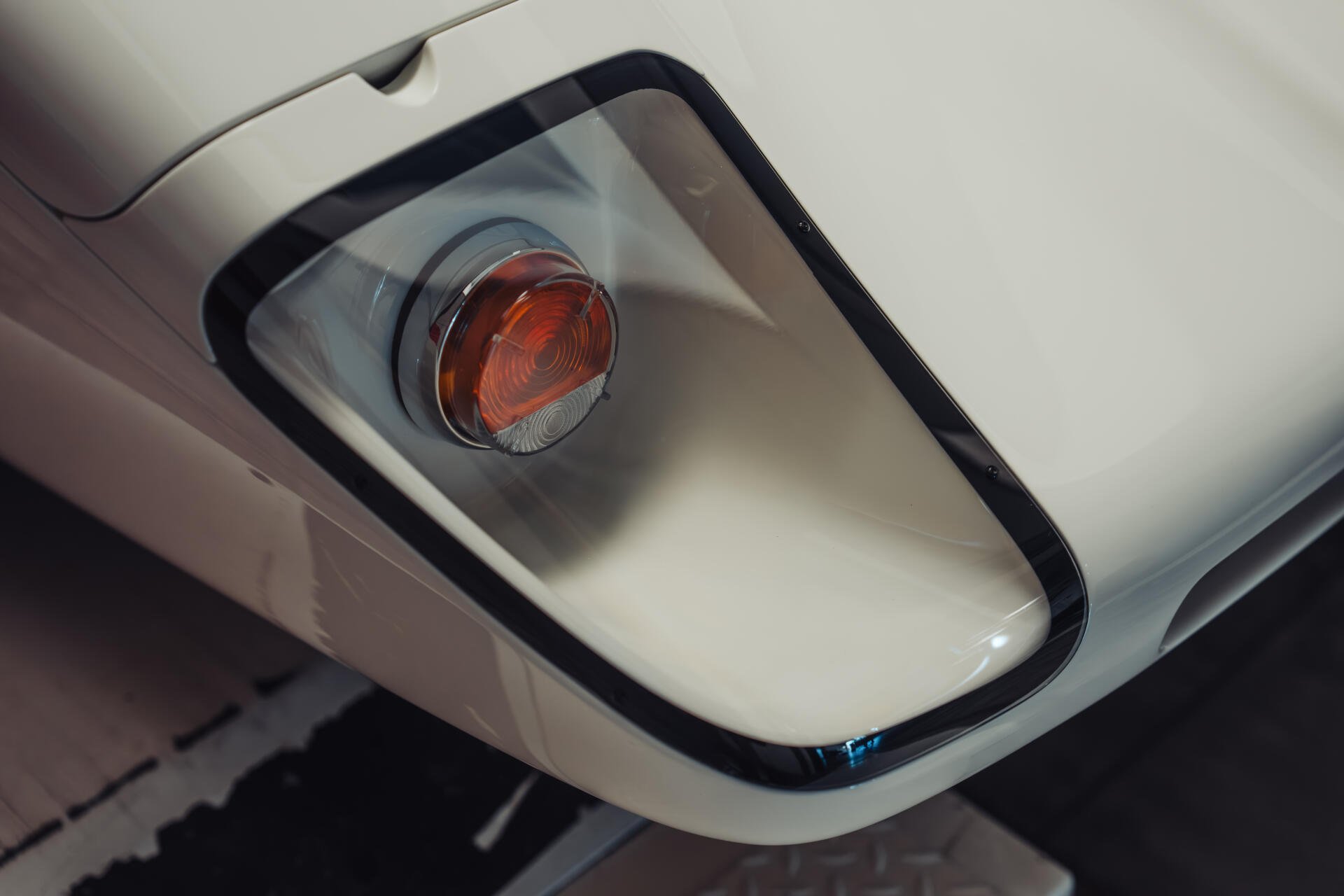 Close-up of a McLaren G6GT front headlight and bumper, white sports car detail rendered as an 8K Ultra HD PC desktop wallpaper background.
