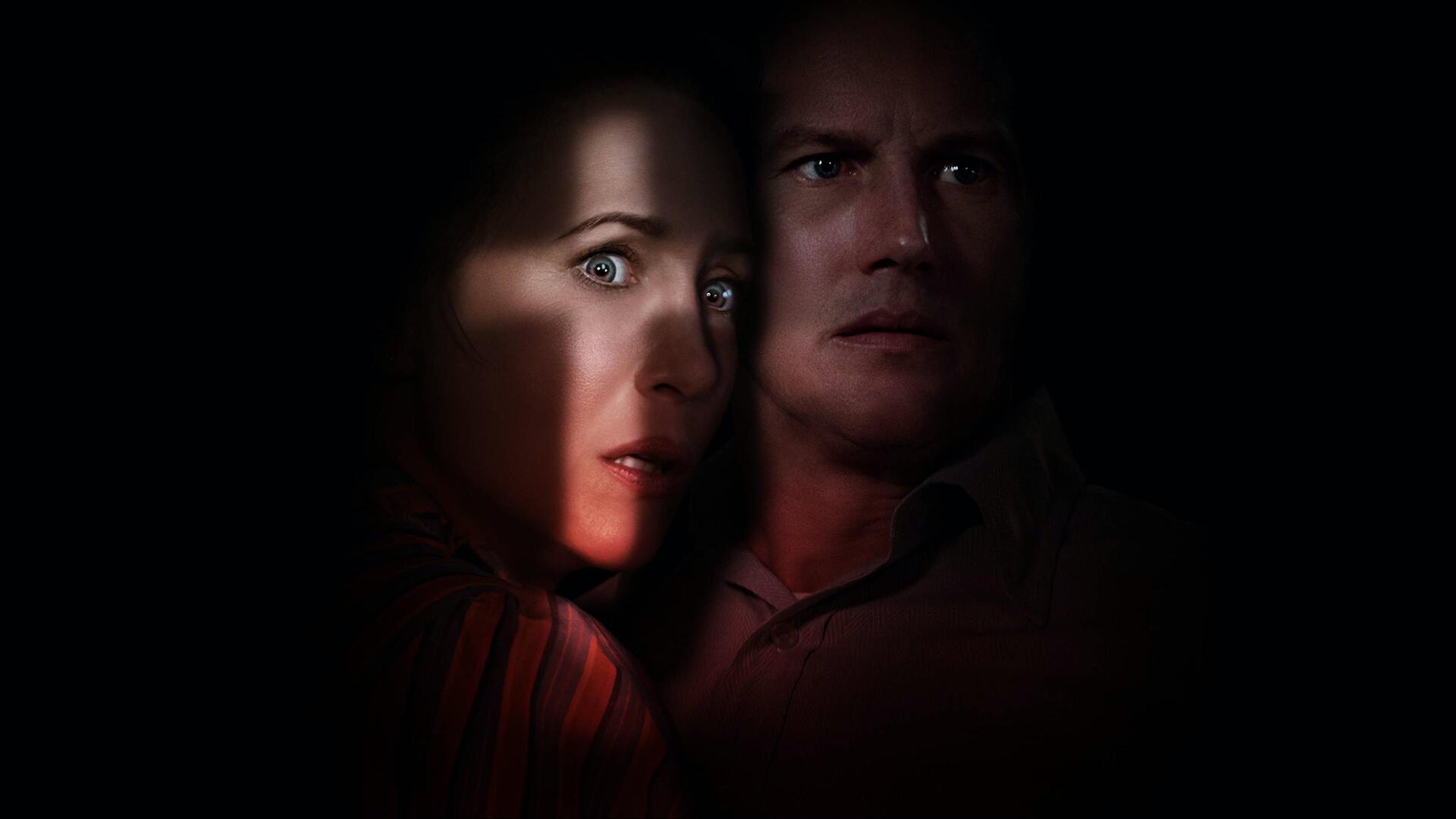 Dark 4K Ultra HD PC desktop wallpaper for The Conjuring: The Devil Made Me Do It showing two tense, shadowed faces lit by a narrow beam of light against a black background.