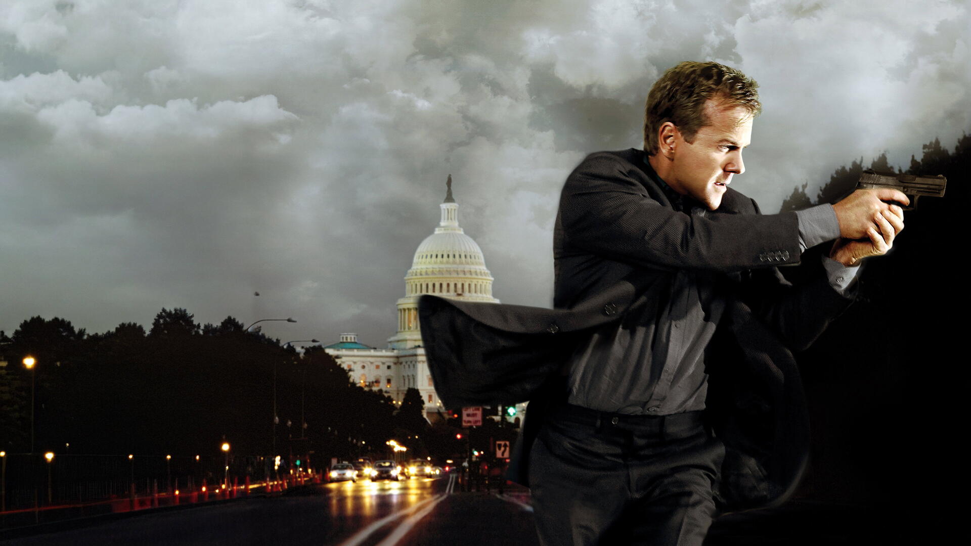 Man in dark suit aiming a handgun in front of the U.S. Capitol at night, storm clouds and wet streets illuminated by city lights — 24, 4K Ultra HD PC Desktop Wallpaper and Background.