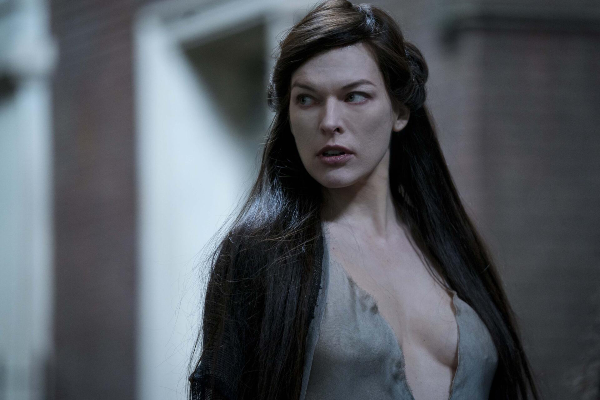 4K Ultra HD PC wallpaper: dark-haired woman in a plunging period/fantasy gown, intense gaze and cinematic lighting, Hellboy (2019)–themed background.