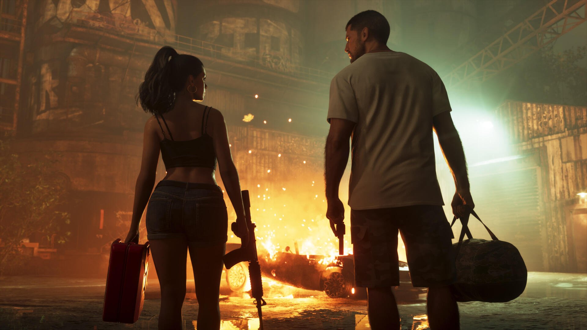 4K Ultra HD desktop wallpaper for Grand Theft Auto VI: Jason and Lucia walk side-by-side through a burning urban street, armed and carrying duffel bags.