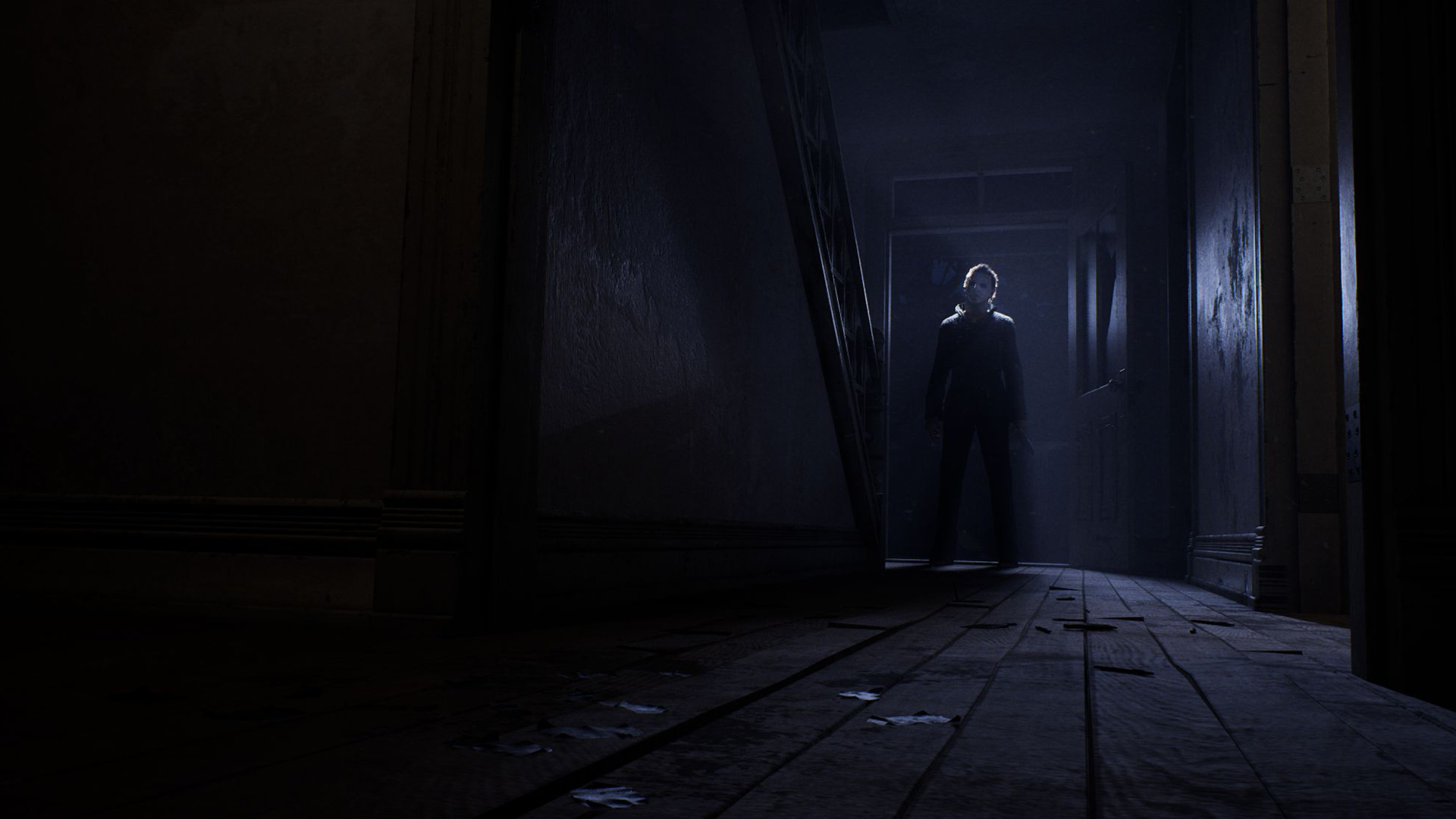 HD PC desktop wallpaper depicting Michael Myers (Halloween: The Game) silhouette standing at the end of a dark, decaying hallway.