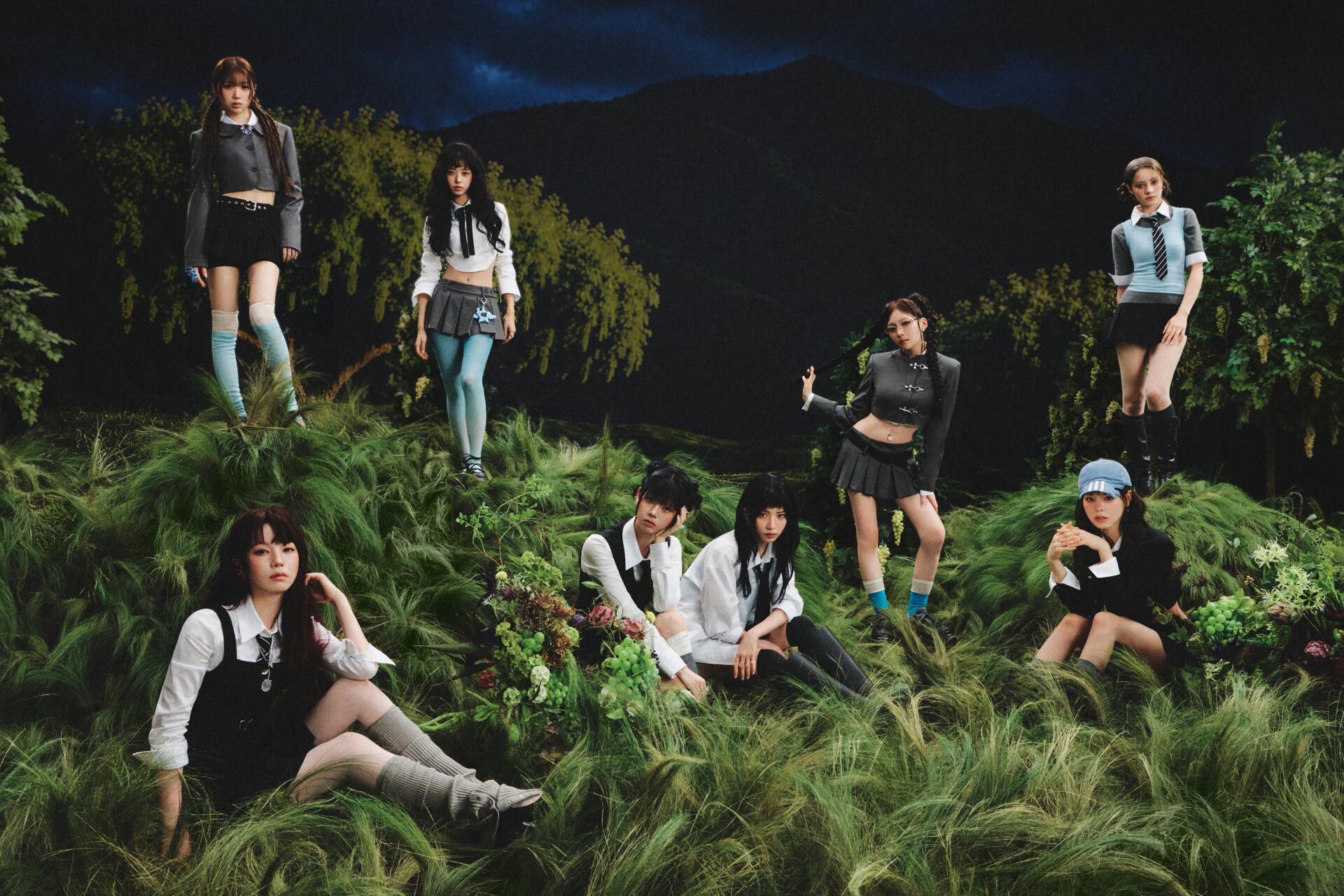 4K Ultra HD PC desktop wallpaper tagged NiziU and Sour Grapes: seven women in coordinated outfits posed among tall grass under a moody, moonlit sky.