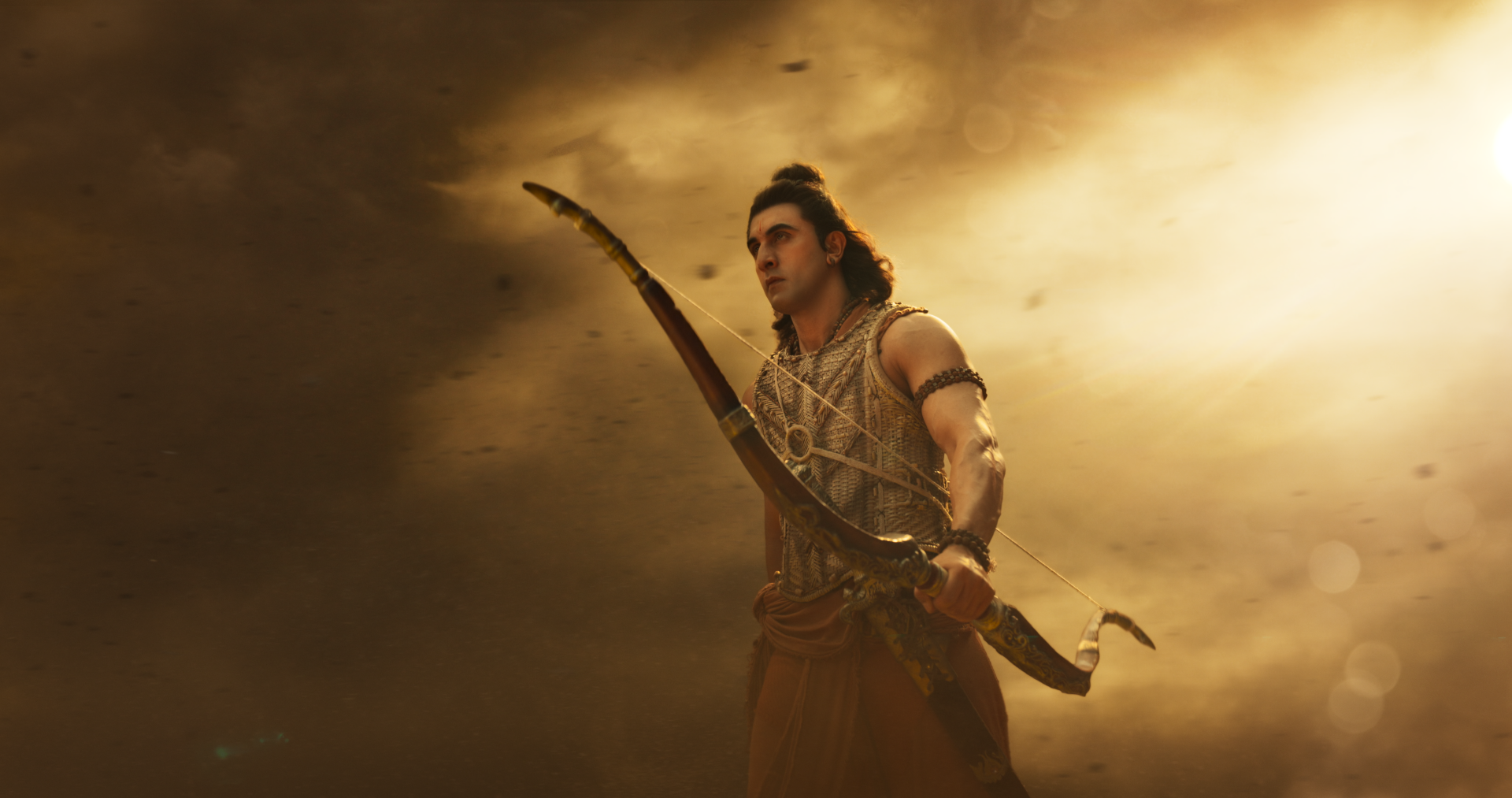 4K Ultra HD PC desktop wallpaper: warrior archer from Ramayana (2026) holding a bow against dramatic golden clouds.