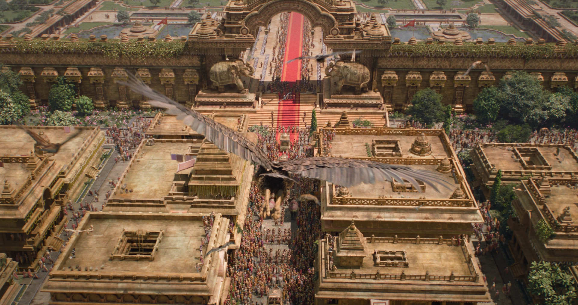 Aerial view of an ornate temple complex and crowded procession from Ramayana (2026), showcasing intricate architecture in a dramatic 4K Ultra HD PC desktop wallpaper and background.