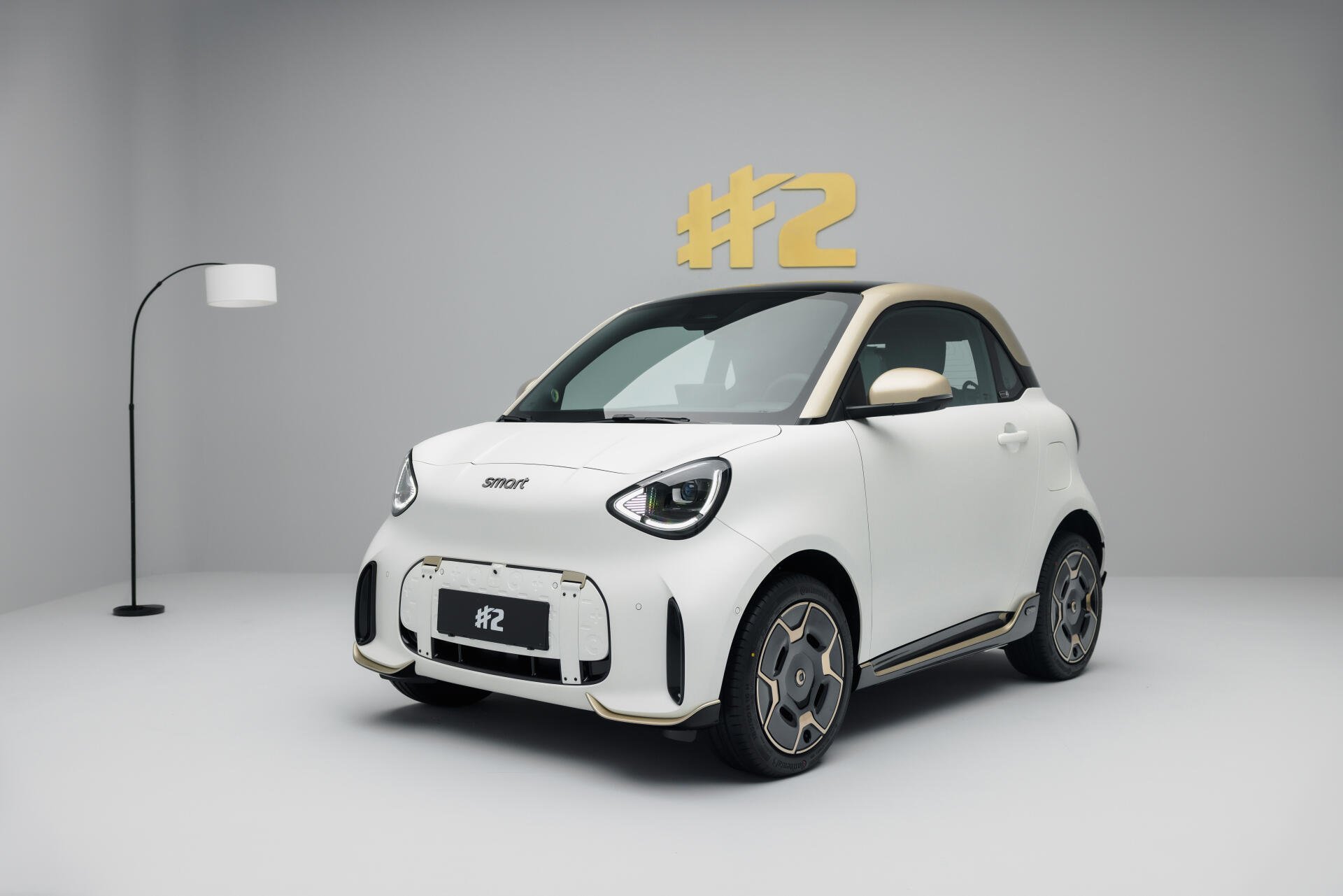 White smart #2 electric compact car in a minimalist studio, featured in an 8K Ultra HD desktop wallpaper.