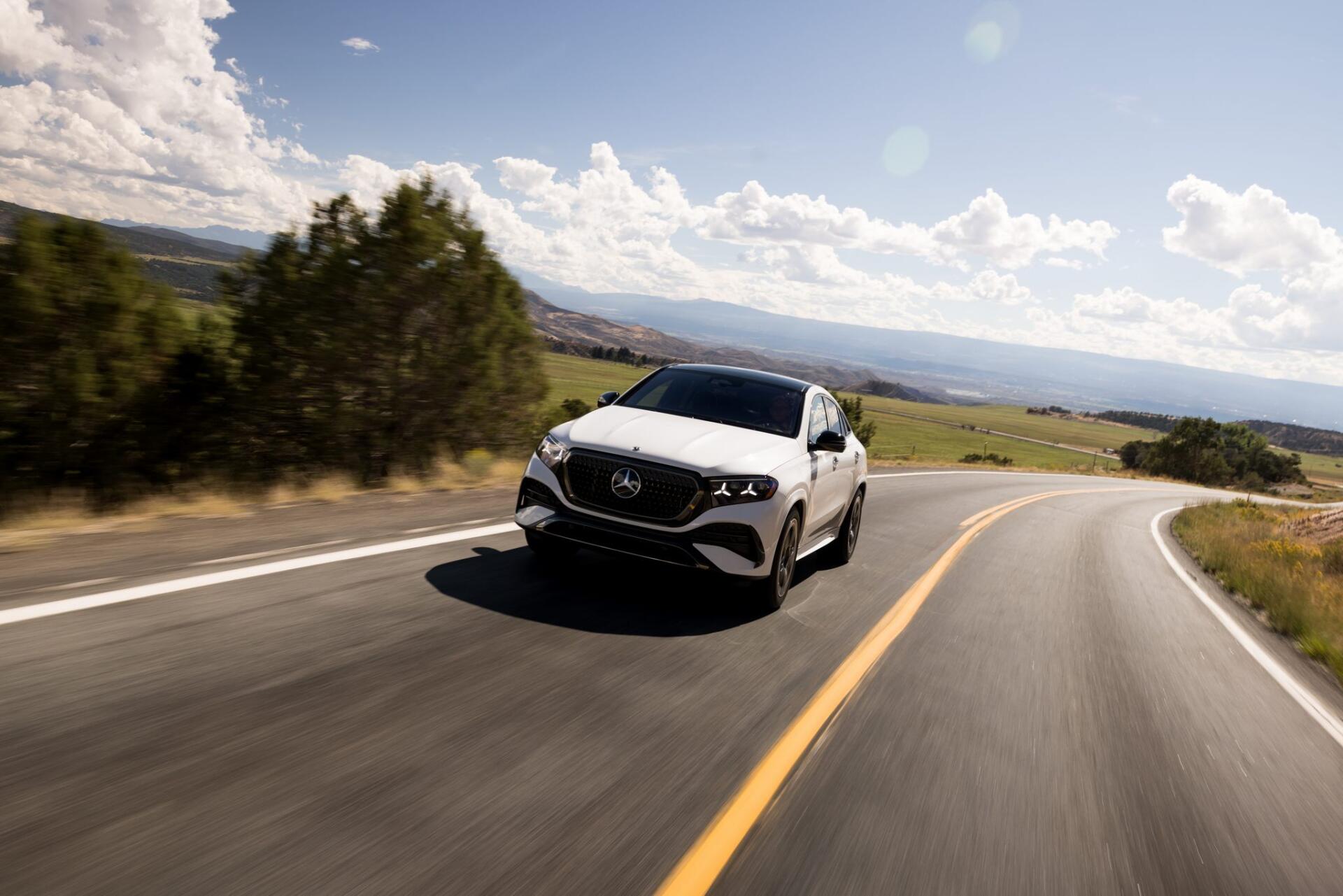 Mercedes-Benz GLE Coupe driving along a winding country road, HD desktop wallpaper and background.