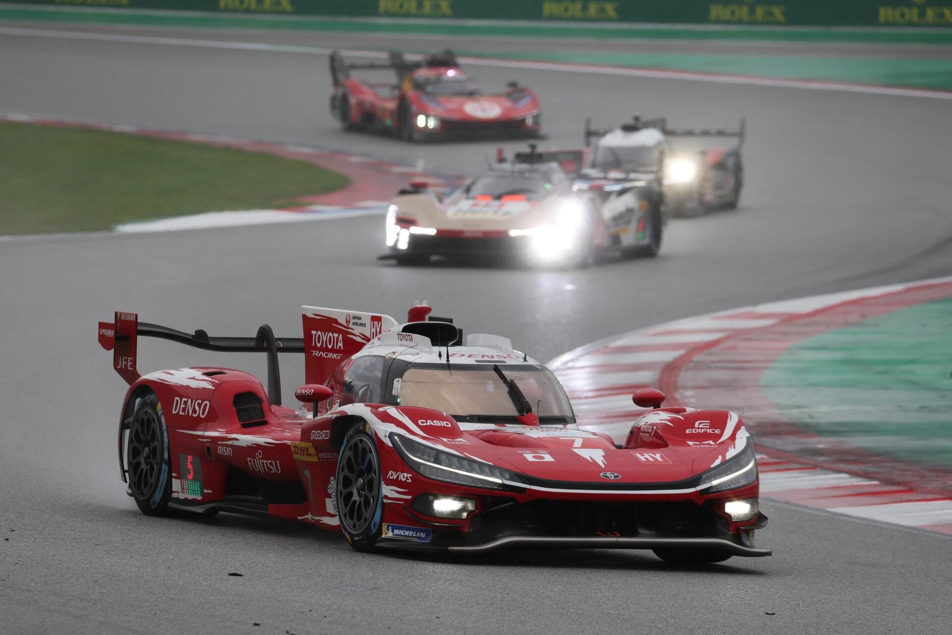 Toyota TR010 Hybrid race cars speed around a circuit in the FIA World Endurance Championship, featured in a 5K Ultra HD desktop wallpaper.