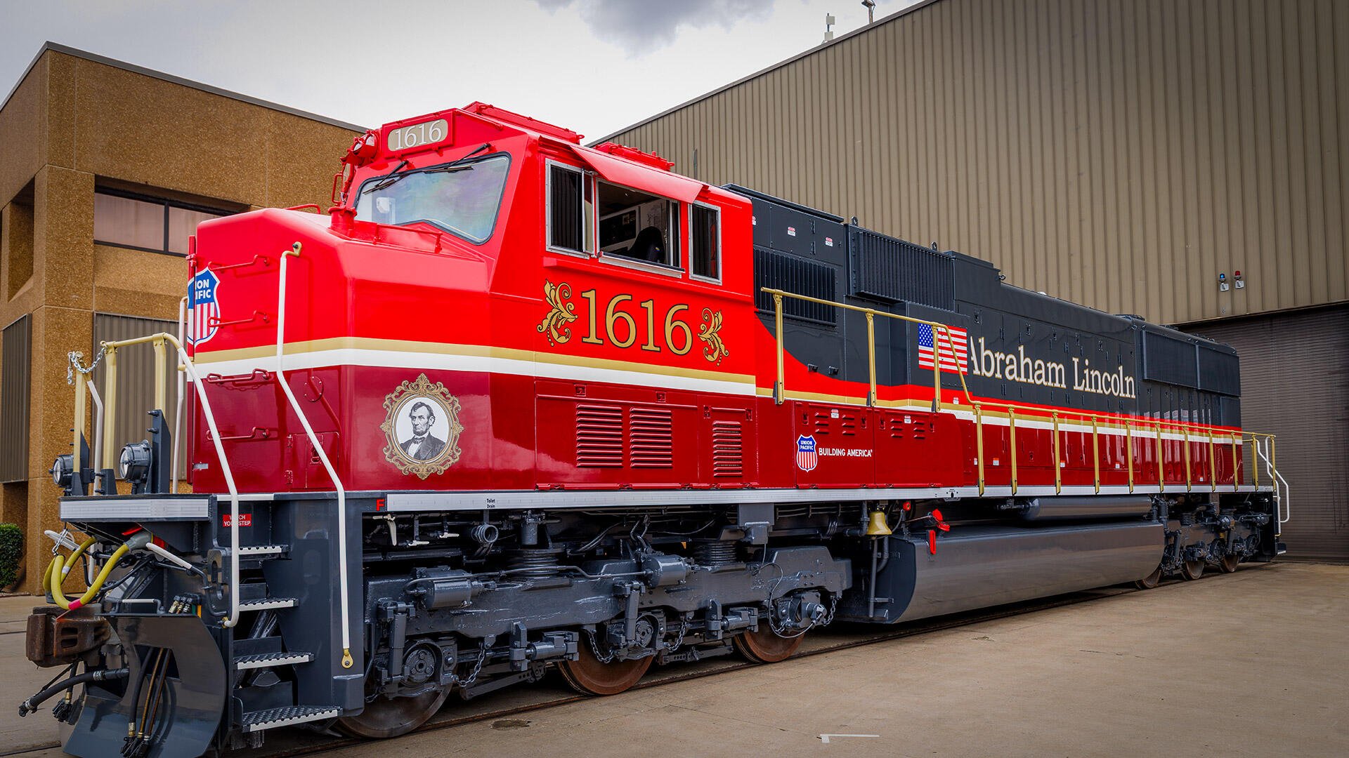 Red Union Pacific Railroad locomotive 1616 on display beside a station, featured in a high-definition train desktop wallpaper.