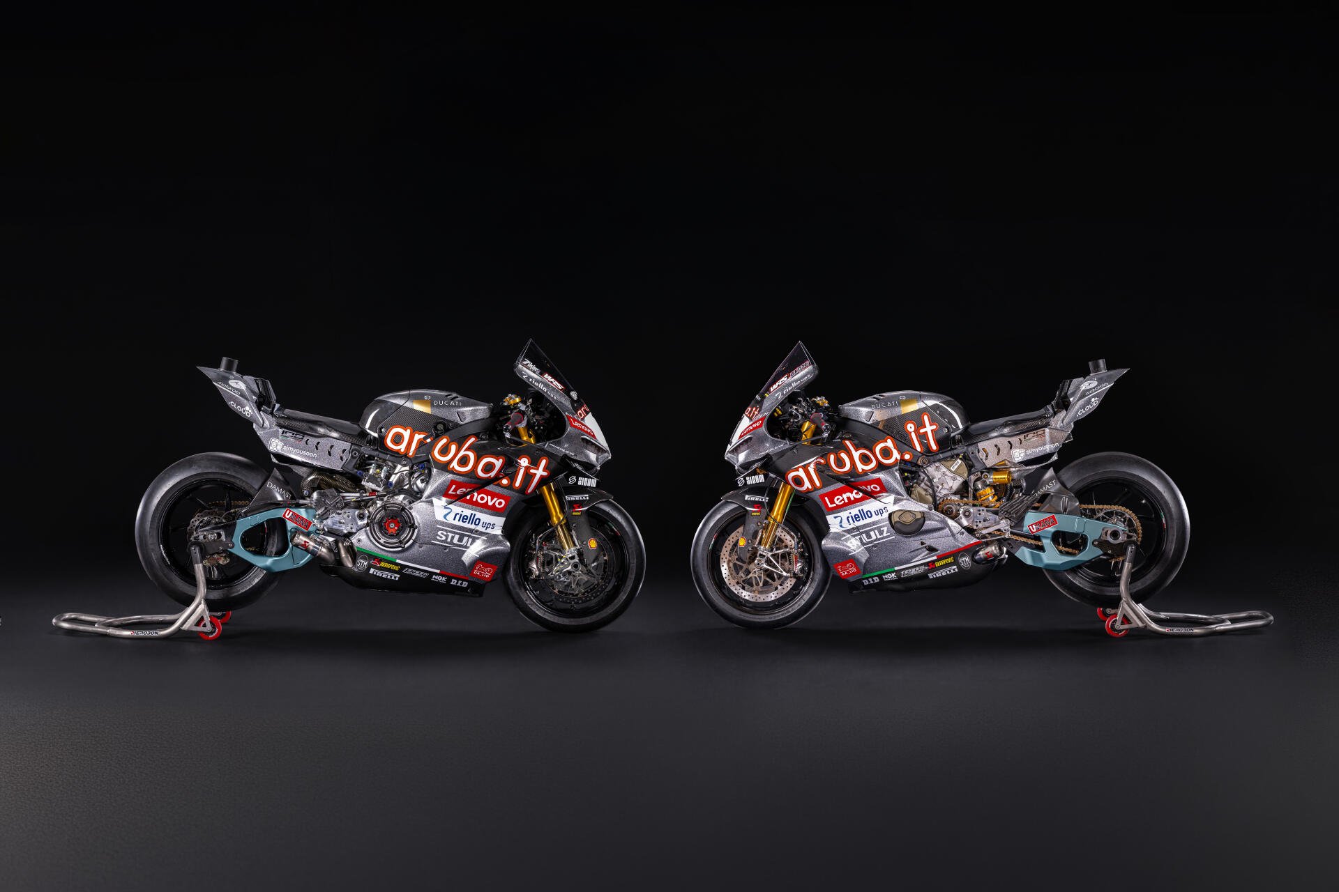 Ducati Panigale V4 R racing motorcycles facing each other against a dark background, 8K Ultra HD desktop wallpaper.