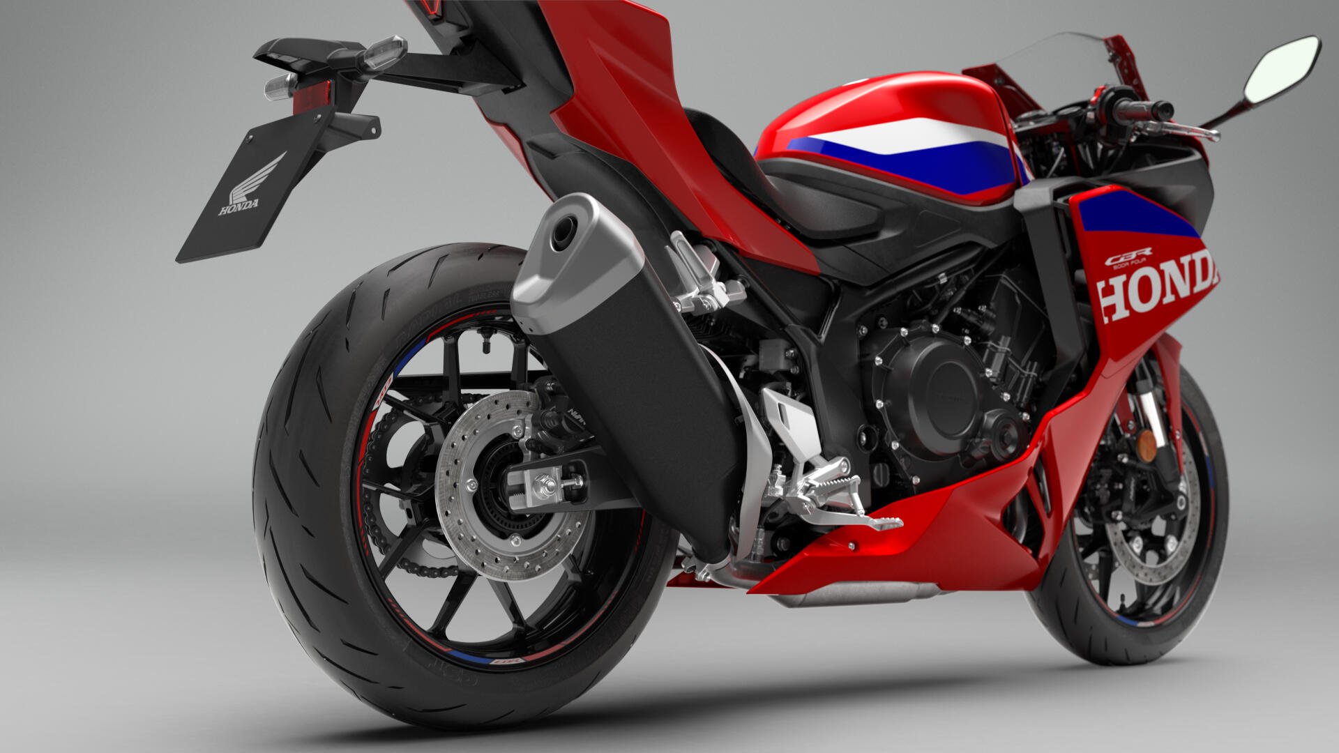 Red Honda CBR500R Four sport bike in a studio, featured in a 4K Ultra HD desktop wallpaper.