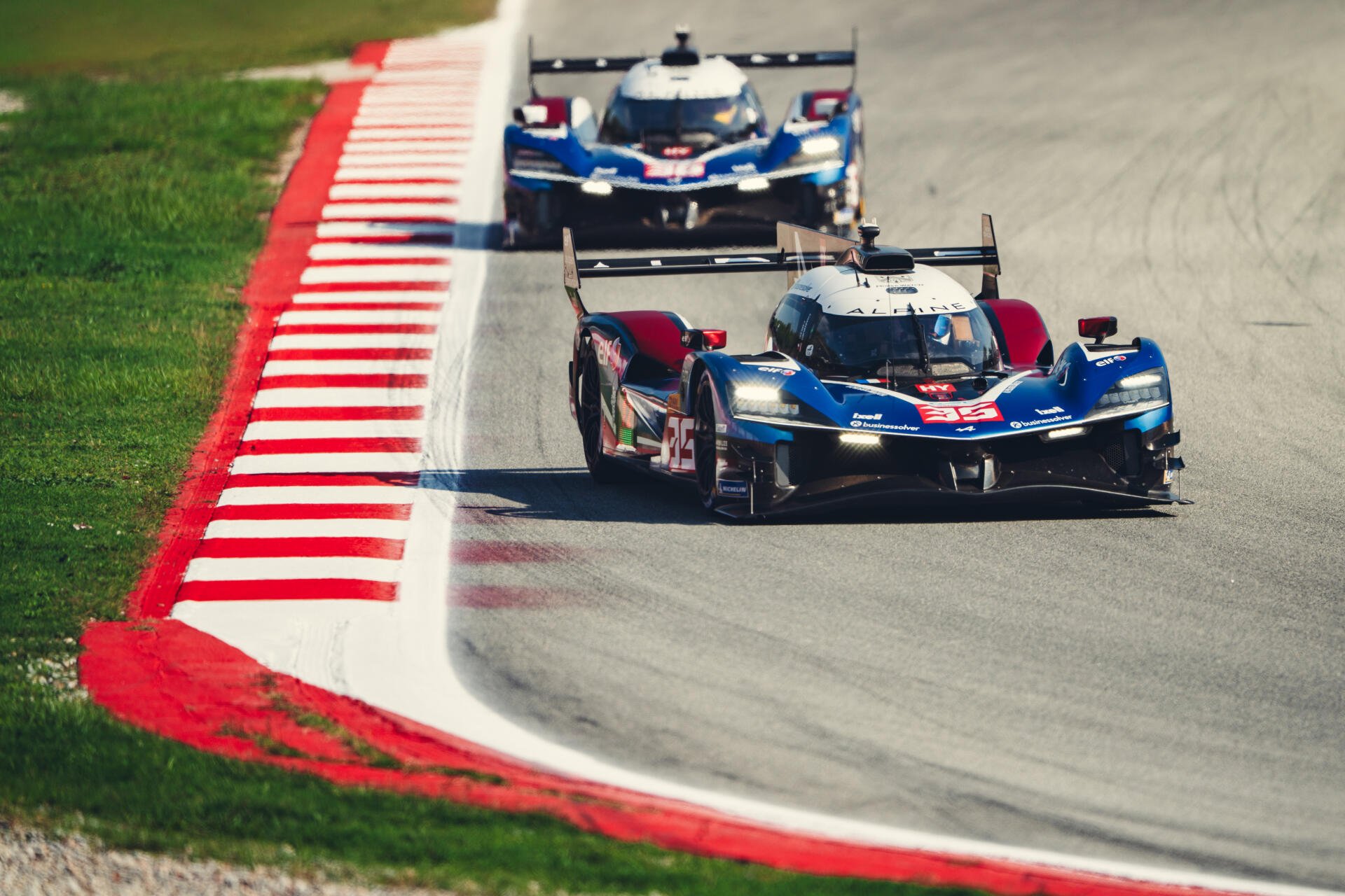 Alpine A424 race cars speeding along a race track, captured in a 5K Ultra HD desktop wallpaper.