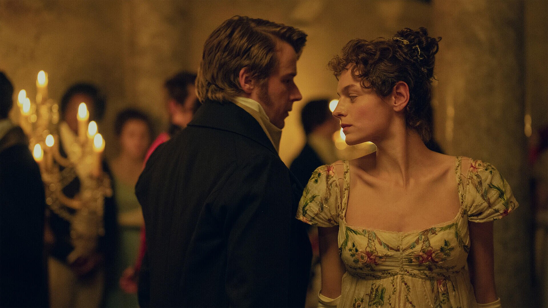 Emma Corrin and Jack Lowden as a couple in a candlelit Regency ballroom in Pride and Prejudice (2026), HD desktop wallpaper.