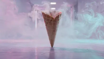 4K Ultra HD PC desktop wallpaper of a single waffle cone balanced on its tip, surrounded by pastel pink and blue smoke and soft reflections on a glossy floor.