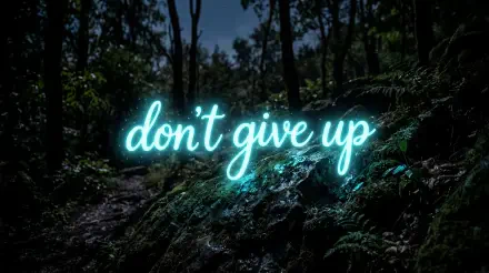 Neon don't give up script glowing over a shadowy forest — 5K Ultra HD PC desktop wallpaper/background.