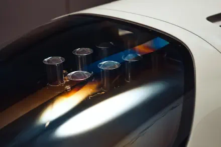 Close-up of McLaren G6GT engine intakes visible through glass; 8K Ultra HD vehicle PC desktop wallpaper and background.