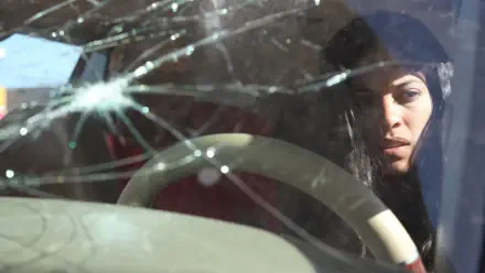 Close-up of a woman behind a cracked windshield, brooding cinematic shot from Miss Bala — 4K Ultra HD PC desktop wallpaper and background.