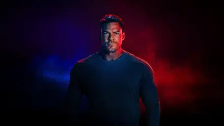 Reacher stands in dramatic red and blue backlight, muscular silhouette centered on a dark scene — 4K Ultra HD PC desktop wallpaper and background.