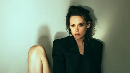 4K Ultra HD desktop wallpaper: moody portrait of a female actress/celebrity seated against a pale wall, wearing a dark blazer, tousled hair and a contemplative expression.