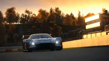 Gran Turismo 7 sports race car speeding on a sunset track, 4K Ultra HD PC desktop wallpaper and background.