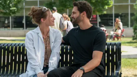 The Love Hypothesis — a couple sit close on a park bench, smiling and gazing at each other; 4K Ultra HD PC desktop wallpaper/background.