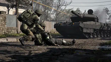WARDOGS Team17 4K PC wallpaper: military combat scene of soldiers aiding a wounded comrade beside an armored tank in a muddy, war-torn urban landscape.
