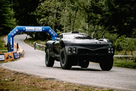 Genesis X Skorpio supercar rally racer on a forest road passing a finish arch, black sports/race car — 4K Ultra HD PC desktop wallpaper background.