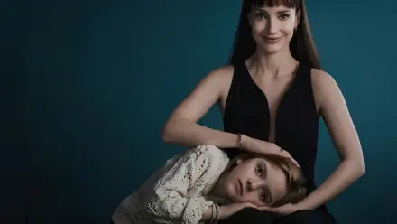 Other Mommy (2026) 2K Quad HD PC desktop wallpaper featuring a woman in black with a child resting on her lap against a dark teal background.