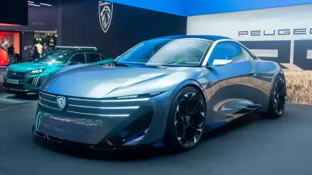 Peugeot RCZ Vision concept car on display at an auto show, featured in a 2K Quad HD desktop wallpaper background.