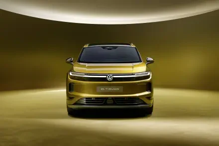 Front view of a gold Volkswagen ID. Tiguan SUV in a dramatic studio, 4K Ultra HD PC desktop wallpaper and background.