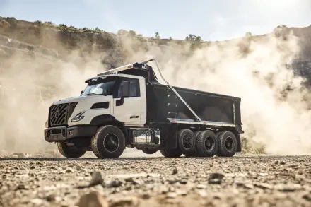 Volvo VNX dump truck hauling across a dusty construction site, captured in crisp 8K Ultra HD PC desktop wallpaper.