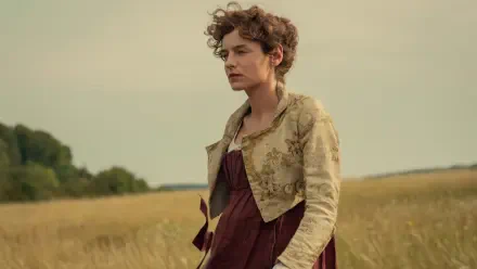 Emma Corrin in a period dress in a golden field from Netflix’s Pride and Prejudice (2026), HD desktop wallpaper.