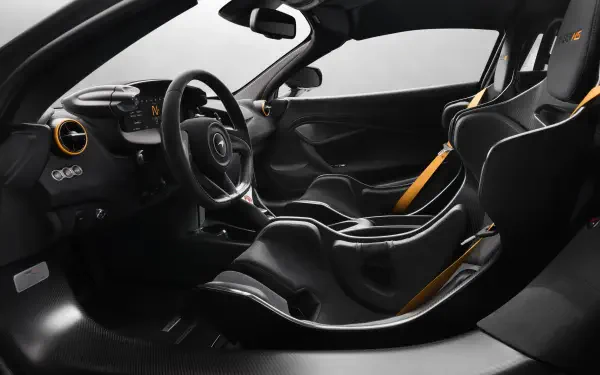 Interior view of a McLaren 788HS sports car with carbon-fiber racing seats, yellow harness accents and a minimalist cockpit — 8K Ultra HD PC desktop wallpaper.