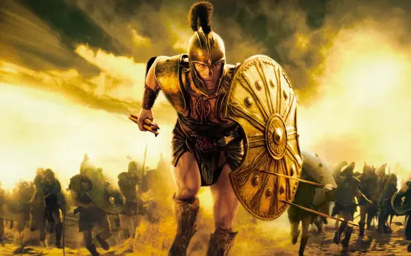 Troy-themed 4K Ultra HD PC desktop wallpaper: armored Trojan warrior charging with shield raised amid a smoky battlefield under golden light.