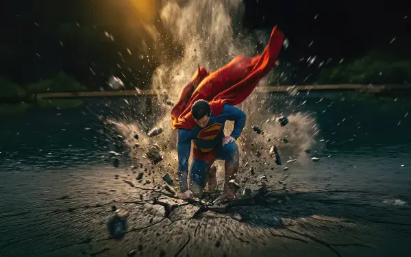 Superman bursts up through shattered ground and water, cape billowing amid flying debris — vivid, high-detail 5K Ultra HD PC desktop wallpaper and background.