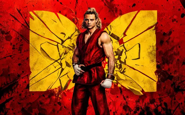 Ken Masters from Street Fighter (2026): a martial artist/fighter in a red gi and gloves stands before a shattered yellow emblem on a red textured backdrop — 4K Ultra HD PC desktop wallpaper/background.