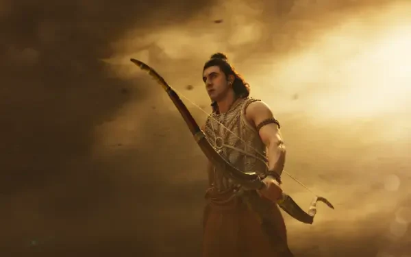 4K Ultra HD PC desktop wallpaper: warrior archer from Ramayana (2026) holding a bow against dramatic golden clouds.