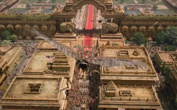 Aerial view of an ornate temple complex and crowded procession from Ramayana (2026), showcasing intricate architecture in a dramatic 4K Ultra HD PC desktop wallpaper and background.