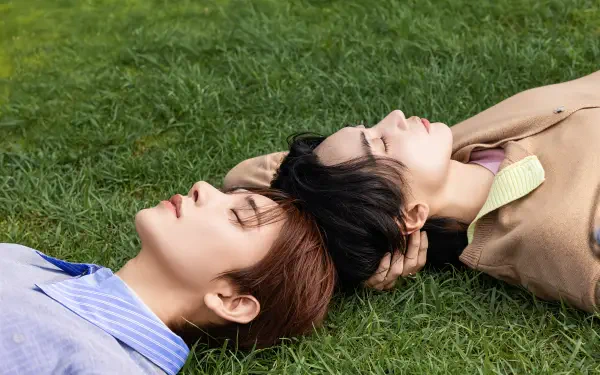 Jeonghan and Joshua Hong of Seventeen reclining on grass, 4K Ultra HD PC desktop wallpaper and background.