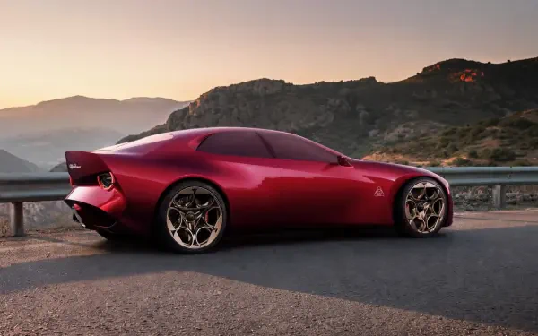 Red Alfa Romeo Cuorerosso concept sports car on a mountain road at sunset, HD desktop wallpaper and background.