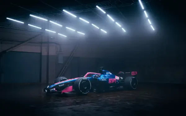Alpine A526 F1 race car in a dramatic, misty garage, featured in an 8K Ultra HD PC desktop wallpaper.