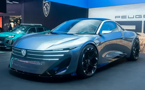 Peugeot RCZ Vision concept car on display at an auto show, featured in a 2K Quad HD desktop wallpaper background.