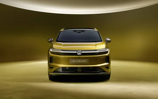 Front view of a gold Volkswagen ID. Tiguan SUV in a dramatic studio, 4K Ultra HD PC desktop wallpaper and background.