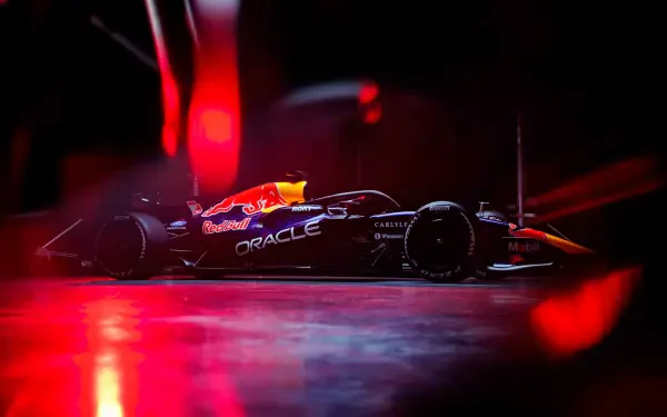 Red Bull Racing RB22 F1 race car under dramatic red lights, 4K Ultra HD PC desktop wallpaper and background.