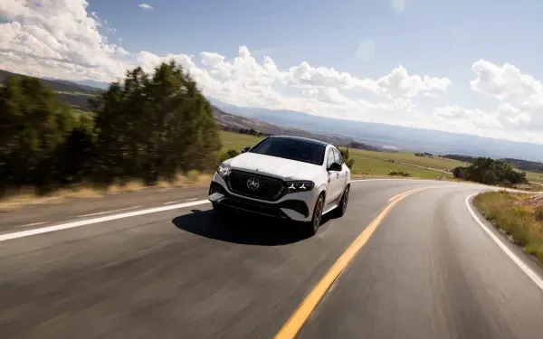 Mercedes-Benz GLE Coupe driving along a winding country road, HD desktop wallpaper and background.